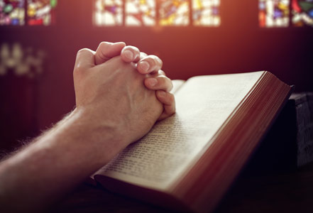 Hands clasped in prayer