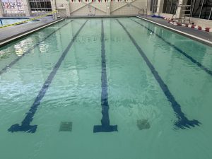 Indoor lap pool viewed from the pool deck