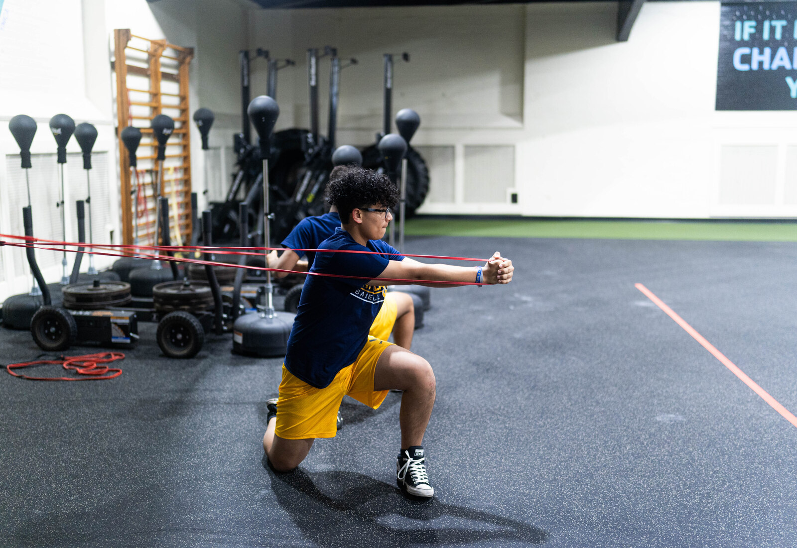 An athlete performing a resistance-band lunge at the Athletic Performance Center