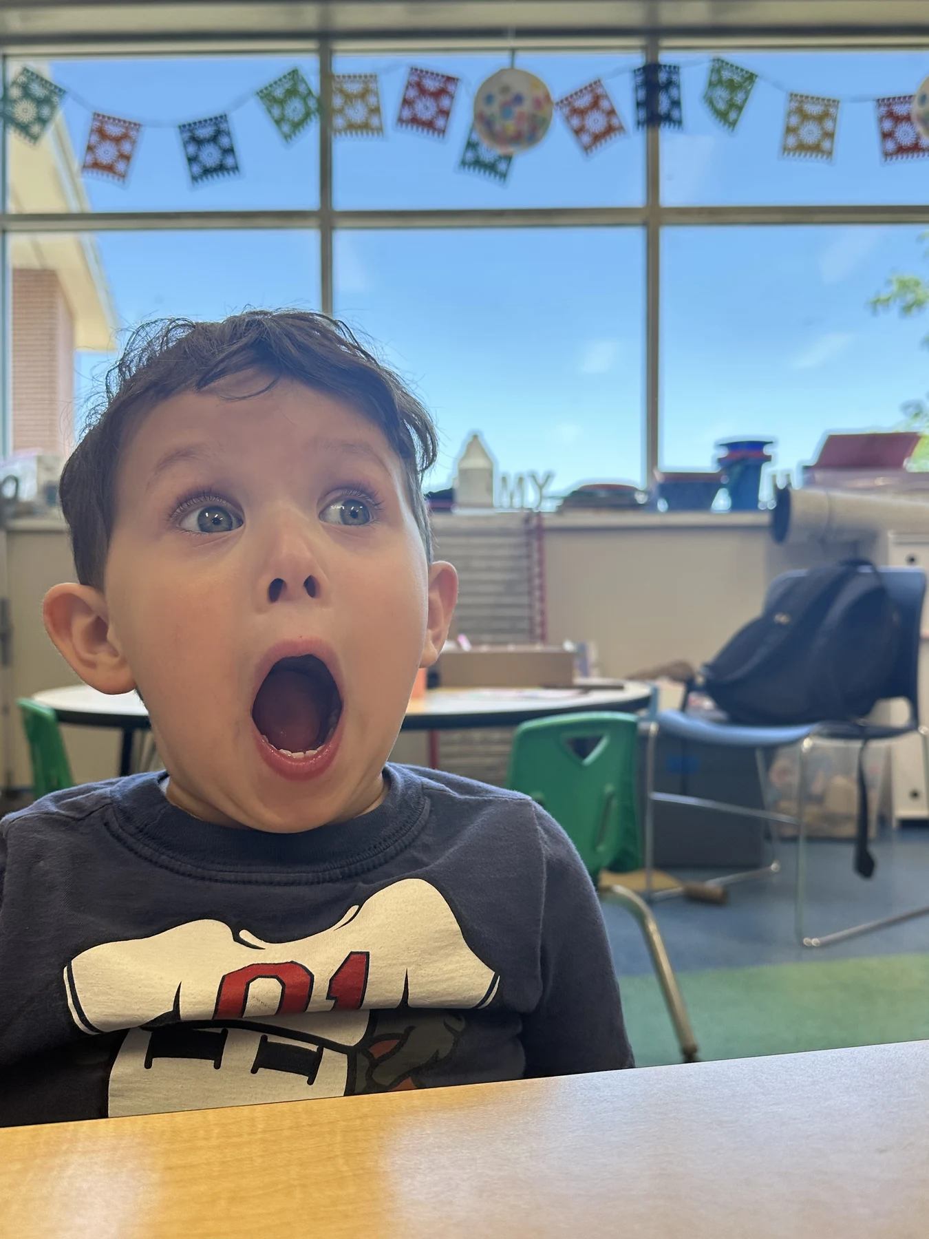 A Camp Neehi boy with wide eyes and an open-mouthed expression of surprise